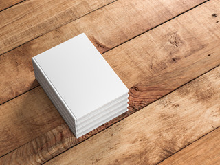 Fototapeta premium Stack White empty books mockup on wooden table