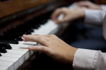 Fototapeta na wymiar Children play piano in four hands