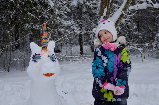 Girl With Snow Made Unicorn