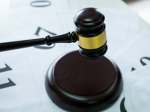 man hold the wooden hamer or the Gavel Handcrafted to judge auction or law.