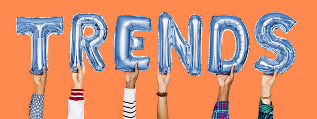 Blue alphabet helium balloons forming the text trends