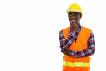 Studio shot of young happy black African man construction worker