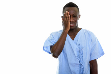 Studio shot of young black African man patient looking sad while