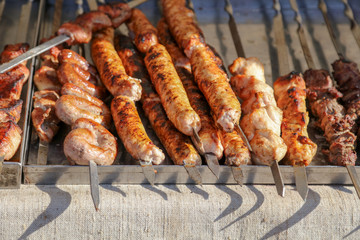 Grilled kebabs on metal sticks in nature