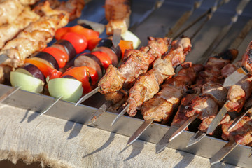 Grilled kebabs on metal sticks in nature