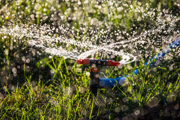 Splashing water to water the lawn as a background