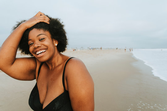 Portrait of smiling woman standing on beach