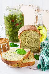 Freshly baked  spinach bread on a white wooden table. Rustic style. Bakery food.