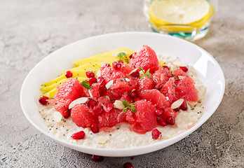 Delicious and healthy oatmeal with grapefruit, pomegranate, almond and chia seeds.  Healthy breakfast. Fitness food. Proper nutrition