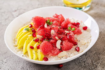 Delicious and healthy oatmeal with grapefruit, pomegranate, almond and chia seeds.  Healthy breakfast. Fitness food. Proper nutrition