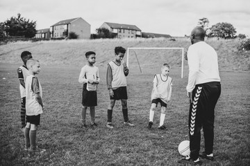 Football coach training his junior players