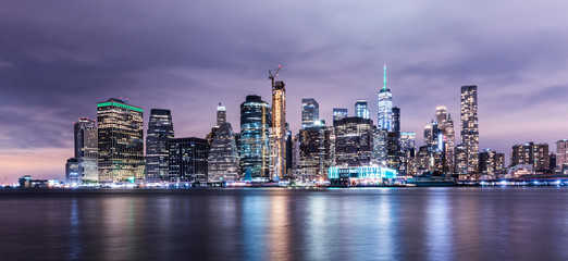 Manhattan panoramic skyline at night. New York City, USA. Office buildings and skyscrapers at Lower Manhattan (Downtown Manhattan)..