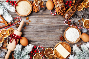 Bakery background with ingredients for cooking christmas baking decorated with fir tree. Flour,...