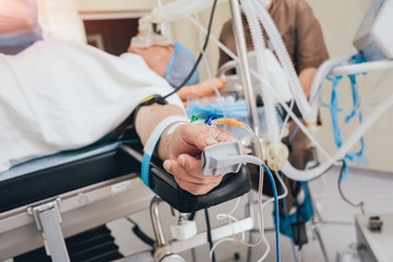 Pulse oximeter on the patient's hand