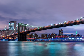 Fototapeta na wymiar Brooklyn Bridge at sunset view. New York City, USA. Brooklyn Bridge is linking Lower Manhattan to Brooklyn..