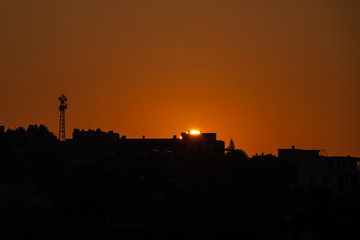Sunrise over the city. Silhouette of the city.