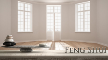 Wooden vintage table shelf with stone balance and 3d letters making the word feng shui over empty...