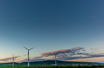 Obraz premium A wind farm in Austria at sunset in Autumn - 1
