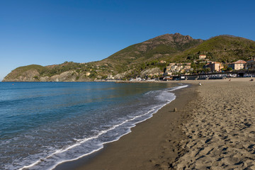 Fototapeta na wymiar Levanto beach lit by the morning sun in a moment of tranquility, Liguria, Italy