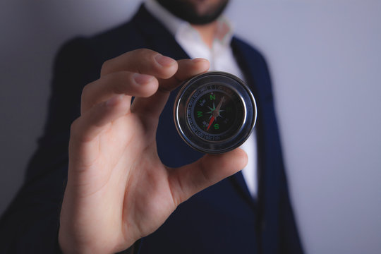 Businessman Holding A Compass