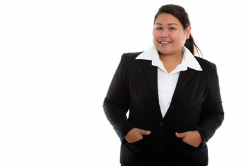 Studio shot of young happy fat Asian businesswoman smiling with 