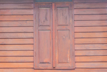 Obraz na płótnie Canvas Vintage wooden window on wood wall in horizontal background