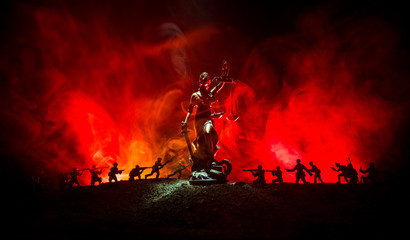 War - no justice concept. Military silhouettes fighting scene and The Statue of Justice on a dark...
