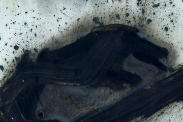 Abstract ink background. Marble style. Black paint stroke texture on white paper. Wallpaper for web and game design. Grunge mud art. Macro image of pen juice. Dark Smear.