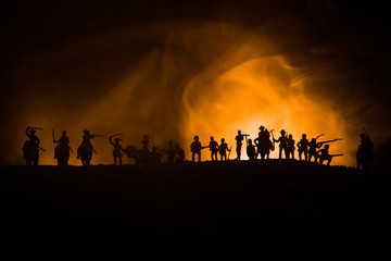 Fototapeta na wymiar American Civil War Concept. Military silhouettes fighting scene on war fog sky background. Attack scene.