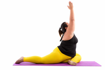 Studio shot of young fat Asian woman stretching her legs and rea