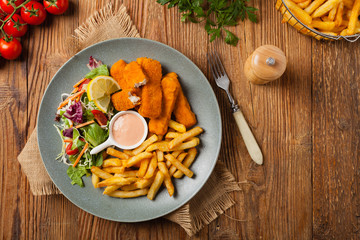Fish sticks with fries and salad.