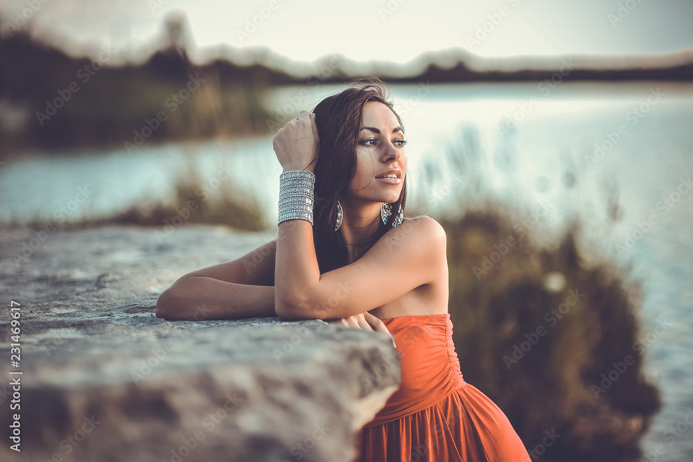 Wall mural Summer portrait of beautiful woman near the lake