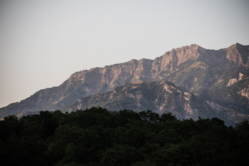 Majestic landscape of the mountains and forest in Caucasus at summer. Dramatic sky with clouds.