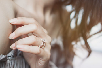 Blurry of an elegant diamond ring on woman finger. soft and selective focus. Love and wedding...