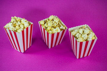 Popcorn in mug on pink background