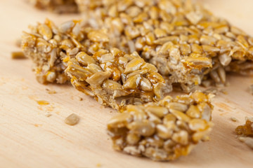broken gozinaki from sunflower seeds on the Wooden board