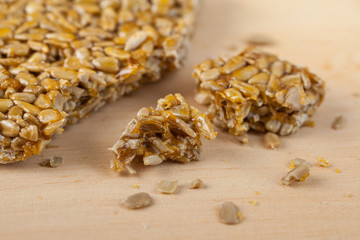 broken gozinaki from sunflower seeds on the Wooden board