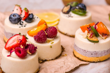 Bright cake with fruit and berries on a light background.