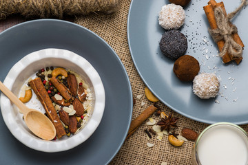 A plate with nuts, cinnamon. Blue dishes on burlap.