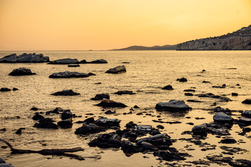 Fototapeta na wymiar Sunset at rocky beach