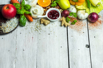 fresh vegetables, fruits, herbs nad spices on white wooden table