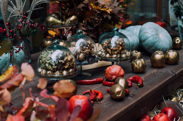Naklejka premium Traditional decor for restaurants during Halloween and Thanksgiving holidays. A colorful pumpkin patch, fruits and vegetables are gifts of autumn.