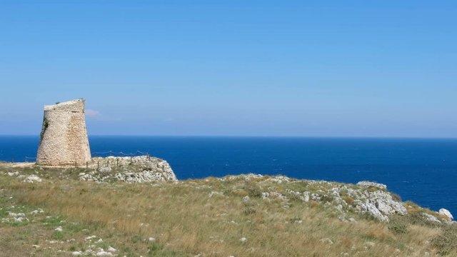 Salento countryside panoramic view panning watchtower coastal seascape grass Apulia Italy