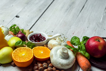 fresh vegetables, fruits, herbs nad spices on white wooden table