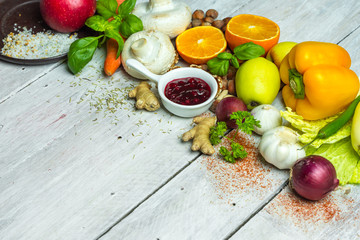 fresh vegetables, fruits, herbs nad spices on white wooden table