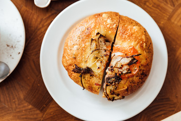Freshly and warm baked with cheese, tomato, onion, anchovies, olive oil and herbs. Made by artisan.
