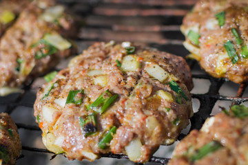 frying cutlets for burgers on the grill