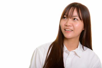 Young happy Asian teenage girl smiling and thinking 