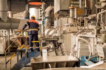 the steelworker supervises the production of aluminum