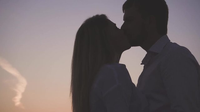 young couple in love outside the city in nature at sunset